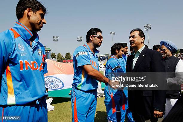 Prime Minister Syed Yusuf Raza Gilani of Pakistan shakes hands with Yuvraj Singh of India as Prime Minister Manmohan Singh of India looks on prior to...