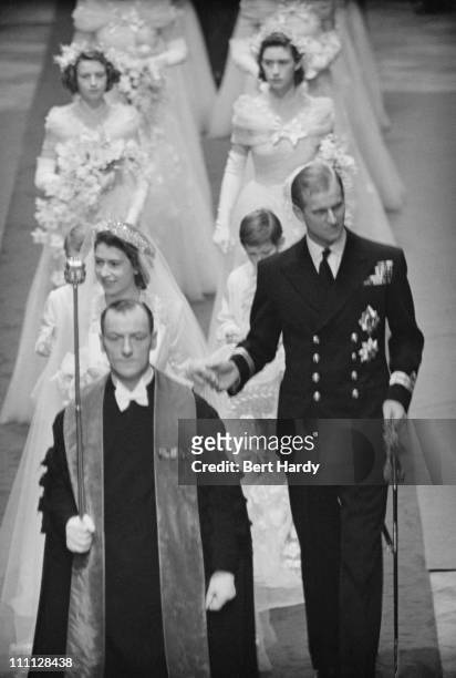 Princess Elizabeth and Prince Philip make their way down the aisle of Westminster Abbey, London, on their wedding day, 20th November 1947. Original...