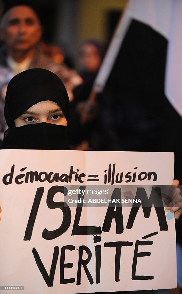 An Islamist Moroccan woman holds a banne