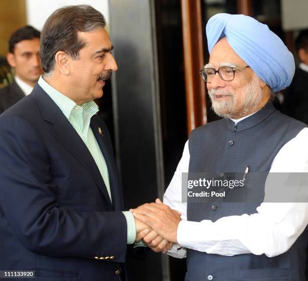 Pakistan Prime Minister Yousuf Raza Gilani shakes hands with Prime Minister Manmohan Singh of India prior to the start of the 2011 ICC World Cup...