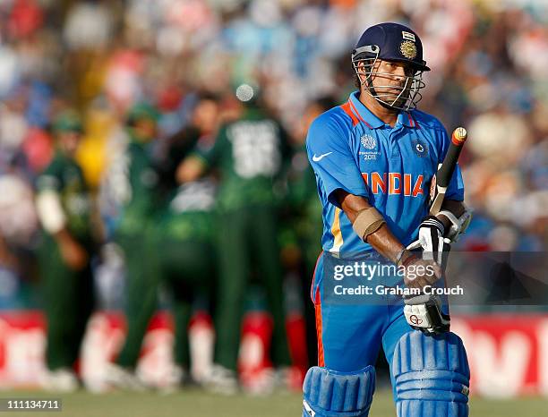 Sachin Tendulkar of India departs after being dimissed for 85 during the 2011 ICC World Cup second Semi-Final between Pakistan and India at Punjab...