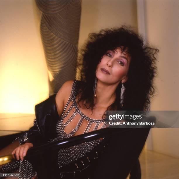 Portrait of American singer and actress Cher as she relaxes in Los Angeles, California, 1987.