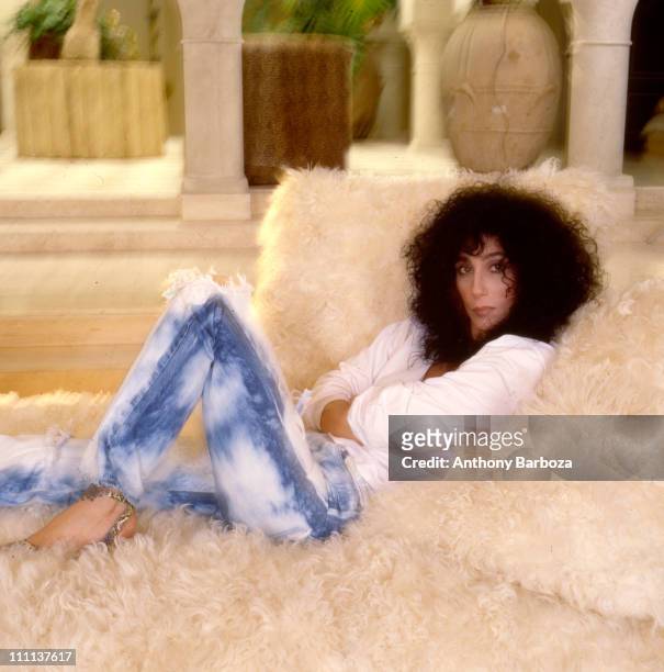 Portrait of American singer and actress Cher as she relaxes in Los Angeles, California, 1987.