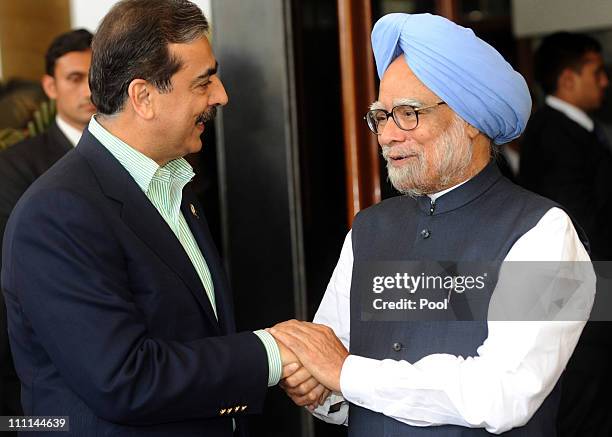 Pakistan Prime Minister Yousuf Raza Gilani shakes hands with Prime Minister Manmohan Singh of India prior to the 2011 ICC World Cup second Semi-Final...