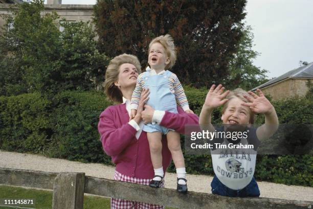 Princes William and Harry with their mother, Diana, Princess of Wales in the garden of Highgrove House in Gloucestershire, 18th July 1986. William is...