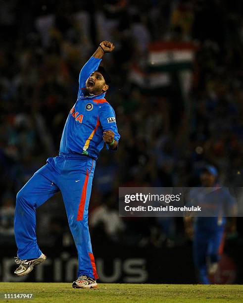 Harbhajan Singh of India celebrates after taking the wicket of Shahid Afridi of Pakistan during the 2011 ICC World Cup second Semi-Final between...