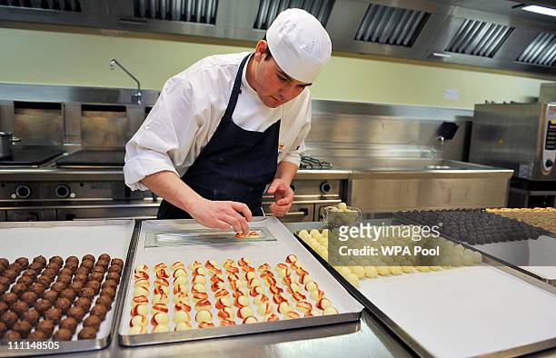 Royal Demi Chef De Partie, Shaun Mason, lays out trays of hand made sweets prepared in the kitchens, akin to that which is usually served at...