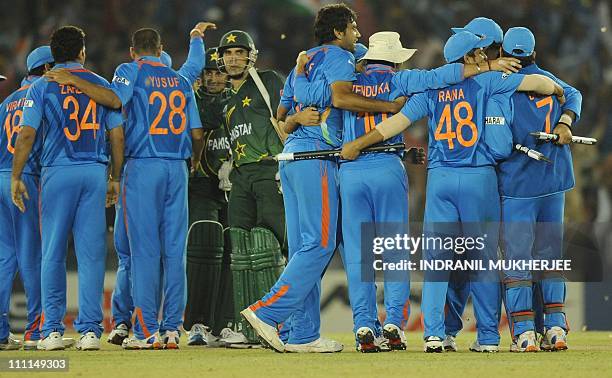 Indian cricketers celebrate after winning the second semi-final match of The ICC Cricket World Cup 2011 against Pakistan at The Punjab Cricket...