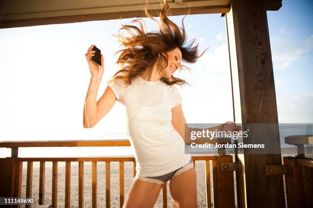 woman dancing on a deck. - headbanging stock pictures, royalty-free photos & images