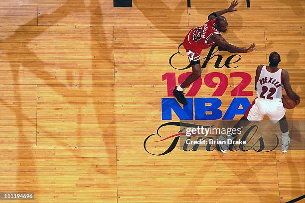 Clyde Drexler of the Michael Jordan of the Portland Trailblazers drives against Michael Jordan of the Chicago Bulls during the 1992 NBA Finas at the...