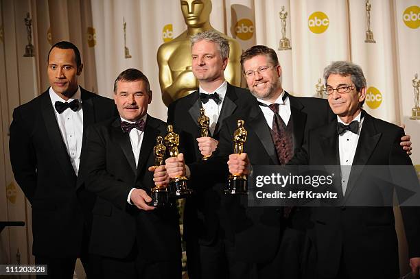 Actor/Presenter Dwayne "The Rock" Johnson and Michael L. Fink, Bill Westenhofer, Ben Morris and Trevor Wood poses in the press room during the 80th...