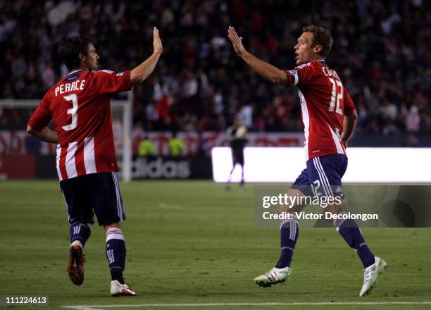 Jimmy Conrad of Chivas USA celebrates his second half goal against Sporting Kansas City with teammate Heath Pearce during the MLS match at The Home...