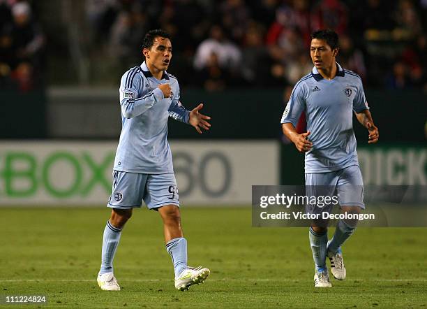 Roger Espinoza of Sporting Kansas City looks on as teammate Omar Bravo gestures to himself during the MLS match against Chivas USA at The Home Depot...