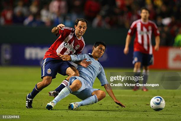 Roger Espinoza of Sporting Kansas City and Nick LaBrocca of Chivas USA vie for the ball during the MLS match at The Home Depot Center on March 19,...