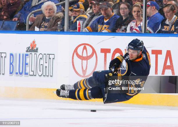 Andrej Sekera of the Buffalo Sabres tries to control the puck after losing his balance against the New York Rangers at HSBC Arena on March 30, 2011...