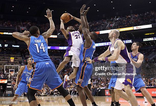 Vince Carter of the Phoenix Suns puts up a shot against Nazr Mohammed of the Oklahoma City Thunder during the NBA game at US Airways Center on March...