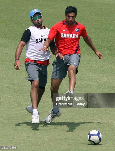 Ashish Nehra and Virat Kohli during a training session at The Punjab Cricket Associaton Stadium in Mohali on March 29, 2011. India will face Pakistan...