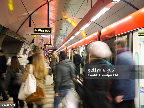 commuters on underground train, london - way out sign stock pictures, royalty-free photos & images