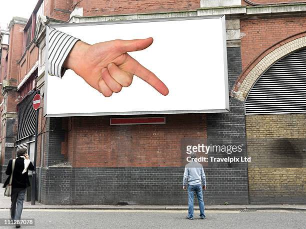 finger on billboard pointing at man - point stock pictures, royalty-free photos & images