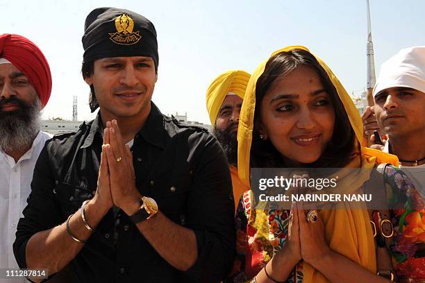 Indian Bollywood fim actor Vivek Oberoi and wife Priyanka pose as they pay their respects at the Golden temple Sikh shrine in Amritsar on March 31,...