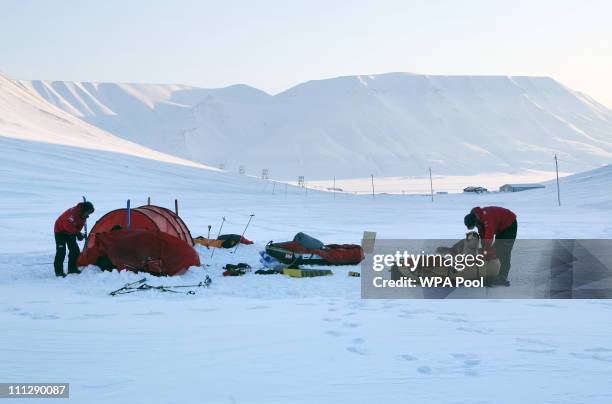 Prince Harry, helped by Inge Solheim , takes down his tent, helped by Inge Solheim , takes down his tent as he joins the Walking with the Wounded...