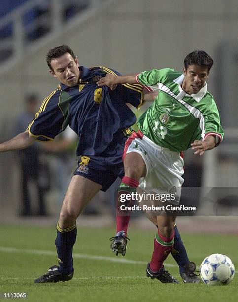 Stan Lazaridis of Australia challenges Pavel Pardo of Mexico, during the 2001 FIFA Confederations Cup Group A match between Mexico and Australia at...