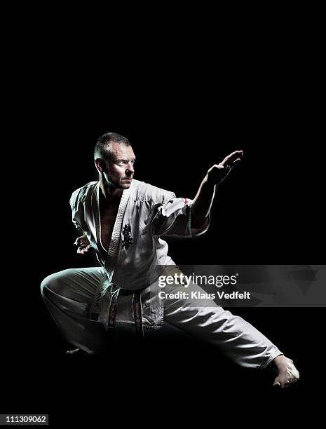 man in karate exercise - karateka stock-fotos und bilder