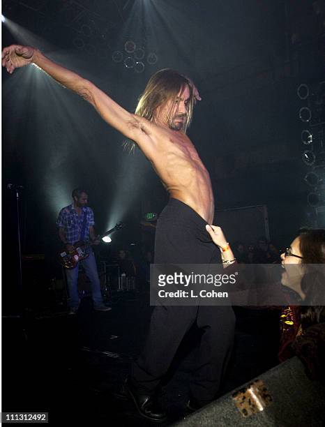 Iggy Pop interacts with a fan as he performs at the 2nd annual 2002 Shortlist music awards concert held at the Henry Fonda Theatre.