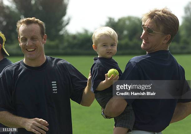 Wade Seccombe of Australia catches up with his Queensland team mate Andy Bichel and Bichel's son Keegan, Bichel is in England playing County cricket...