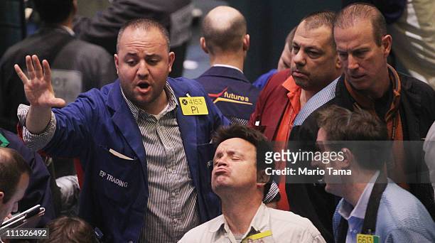 Traders work in the crude oil options pit on the floor of the New York Mercantile Exchange on March 31, 2011 in New York City. The price of oil leapt...