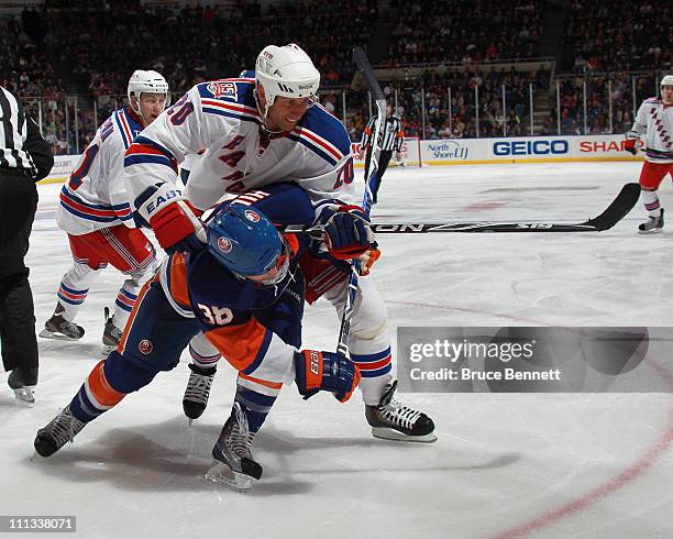 Vaclav Prospal of the New York Rangers gets the stick on Jack Hillen of the New York Islanders at the Nassau Coliseum on March 31, 2011 in Uniondale,...