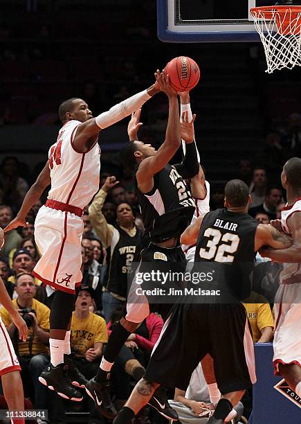 Toure' Murry of the Wichita State Shockers is stopped by Chris Hines of the Alabama Crimson Tide during the 2011 NIT Championship game on March 31,...