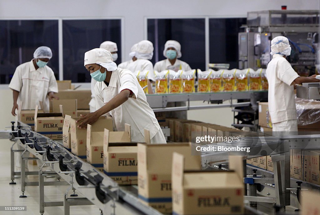 Workers package Filma cooking oil in the warehouse area of the PT