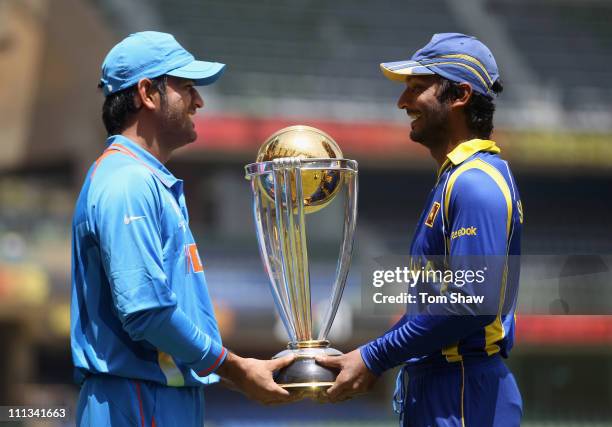 Captains MS Dhoni of India and Kumar Sangakkara of Sri Lanka pose with the ICC World Cup during the India nets session at the Wankhede Stadium on...