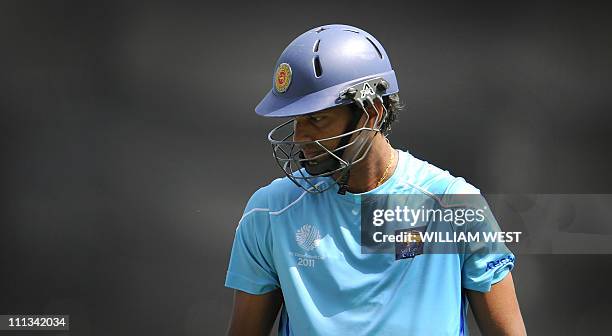 Sri Lankan cricket captain Kumar Sangakkara walks back from batting in the nets during the team's final training session at The Wankhede Stadium in...