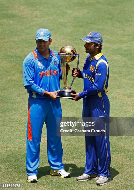 Dhoni, captain of India and Kumar Sangakkara, captain of Sr Lanka, pose with the world cup trophy at Wankhede Stadium ahead of tomorrow's final...