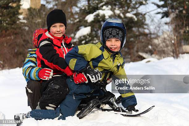 young children riding a snowboard - sweden snowboarding stock pictures, royalty-free photos & images