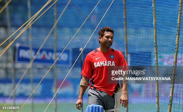 Indian cricketer Sachin Tendulkar walks past the batting nets during a training session at The Wankhede Stadium in Mumbai on April 1, 2011. India...