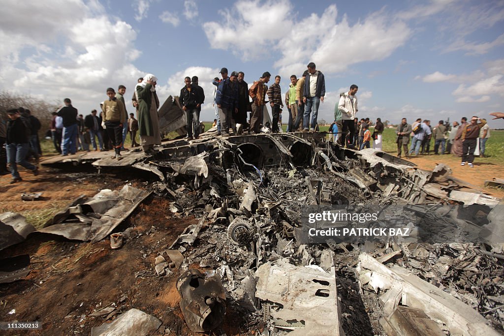Libyans gather around the wreckage of a