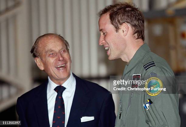 Prince William shares a joke with his grandfather the Duke of Edinburgh during an offical visit to RAF Valley where Prince William is stationed as a...
