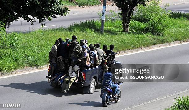 Millitamen loyal to Alassane Ouattara drive a vehicle along a street in Abidjan on April 1, 2011. Ivory Coast strongman Laurent Gbagbo's forces...