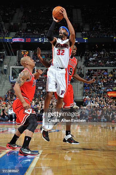 Richard Hamilton of the Detroit Pistons shoots against Luol Deng and Keith Bogans of the Chicago Bulls on March 26, 2011 at The Palace of Auburn...