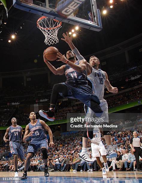 Augustin of the Charlotte Bobcats shoots against Hedo Turkoglu of the Orlando Magic on April 1, 2011 at the Amway Center in Orlando, Florida. NOTE TO...