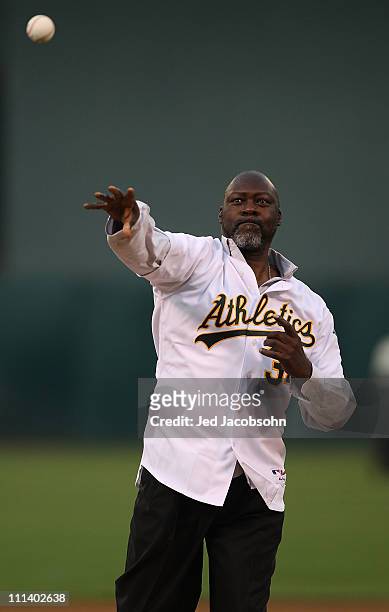 Former Oakland pitcher Dave Stewart throws out the first pitch before the Oakland Athletics and the Seattle Mariners opening day game of Major League...
