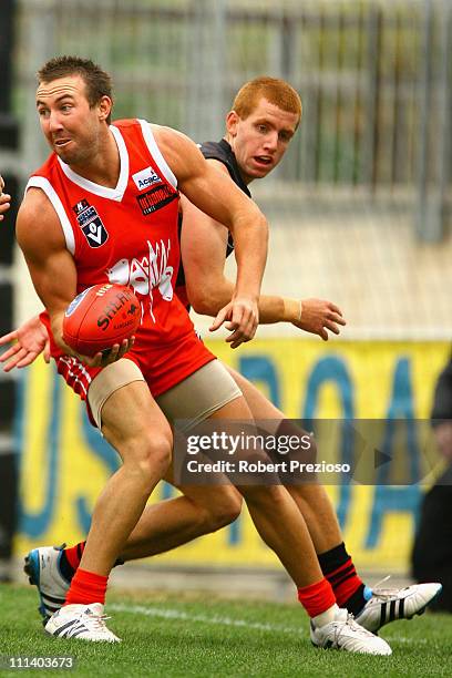 Brock McLean of the Bullants handballs during the round one VFL match between the Northern Bullants and the Bendigo Bombers at Visy Park on April 2,...