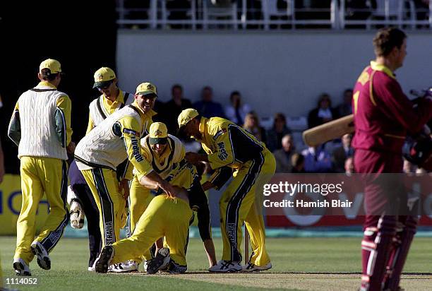 The Australians celebrate after Ian Harvey of Australia ran out Jason Brown of Northhamptonshire to tie the game, during the one day tour match...