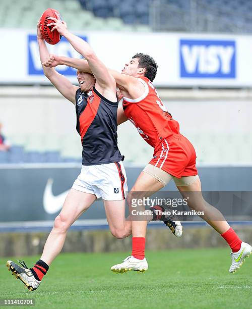 Tyson Thomas of the Bullants attempts to spoil a mark taken by Matthew Little of the Bombers during the round one VFL match between the Northern...