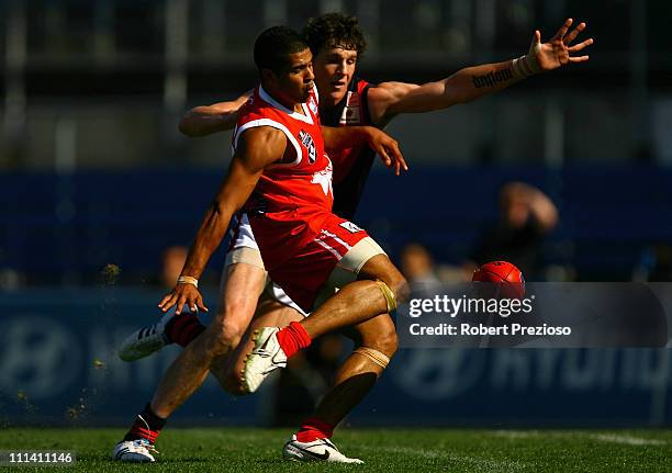 Ahmed Saad of the Bullants kicks for goal under pressure during the round one VFL match between the Northern Bullants and the Bendigo Bombers at Visy...