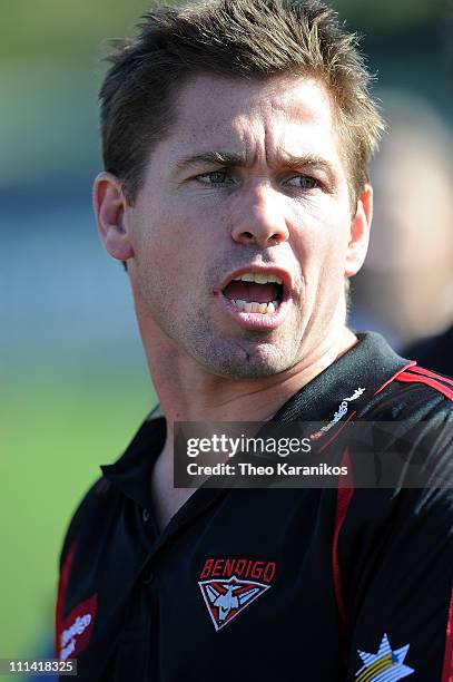 Bendigo Bombers coach Shannon Grant talks to his players at three quarter time during the round one VFL match between the Northern Bullants and the...