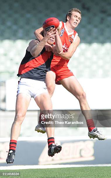 Joe Dare of the Bullants attempts to spoil Ariel Steinburg of the Bombers during the round one VFL match between the Northern Bullants and the...
